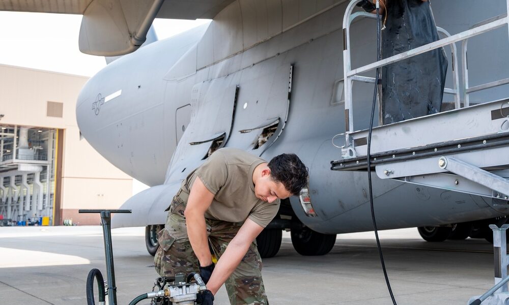 U.S. Air Force technicians performing maintenance on C-17 Globemaster III Integrated Drive Generator electrical system