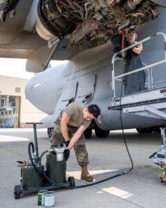 U.S. Air Force technicians performing maintenance on C-17 Globemaster III Integrated Drive Generator electrical system