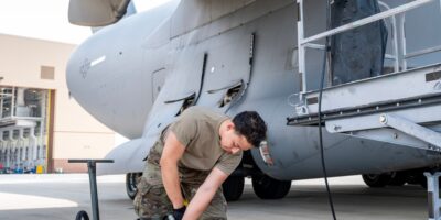 U.S. Air Force technicians performing maintenance on C-17 Globemaster III Integrated Drive Generator electrical system