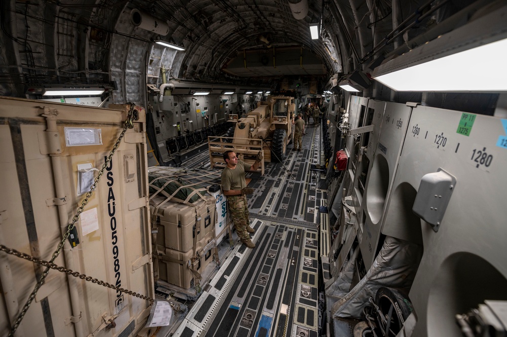 C-17 loadmaster securing cargo