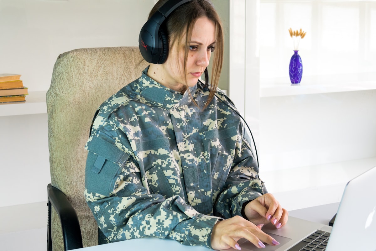 Military servicemember in uniform working on a laptop, representing the transition from active duty to civilian career paths for Air Force loadmaster veterans